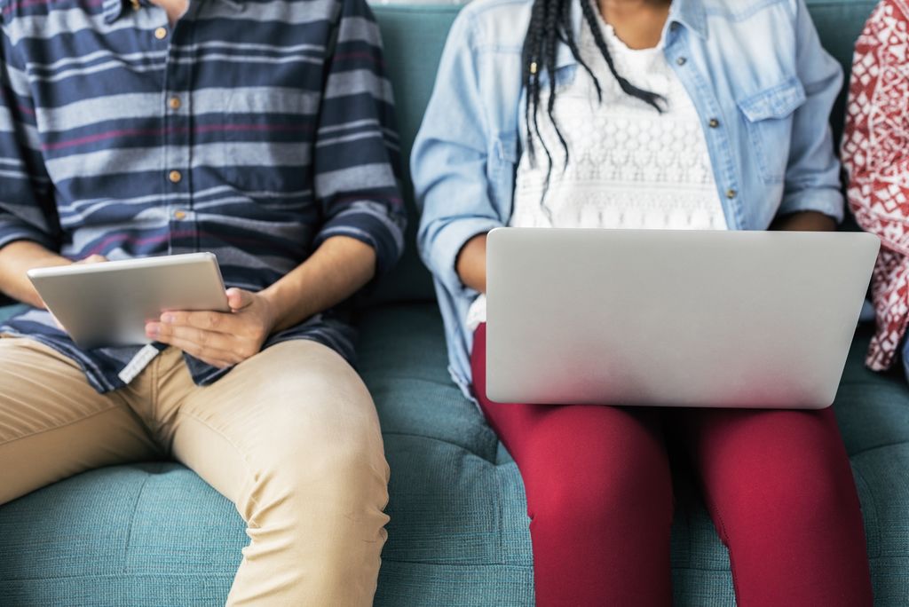 Couple Looking at Computer and Tablet