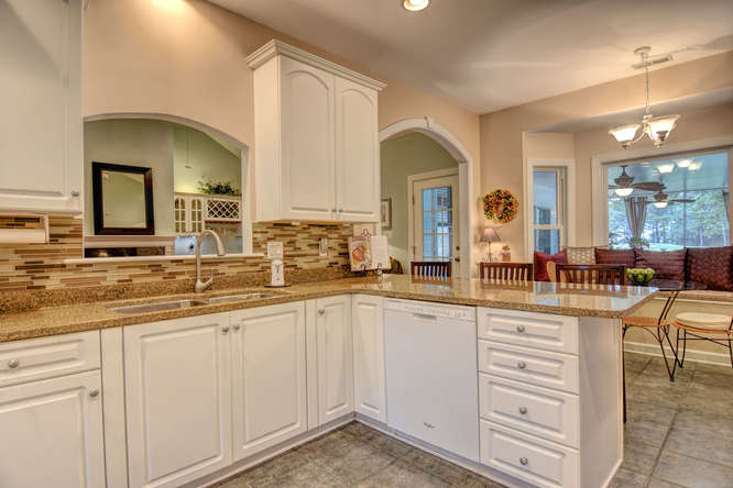 Kitchen with White Cabinets and Bay Window
