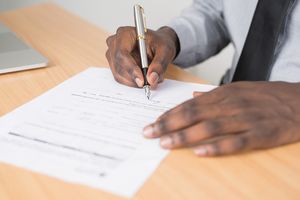 Person Signing Paperwork by Cytonn Photography via Pexels