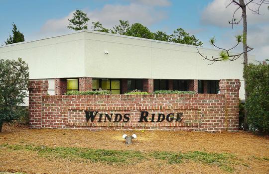 Brick entrance sign outside Winds Ridge