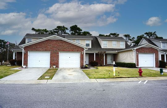 Example townhomes with brick and light tan vinyl siding