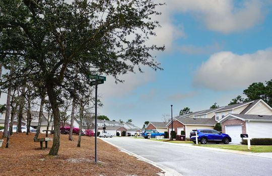 Example townhomes with brick and light tan vinyl siding