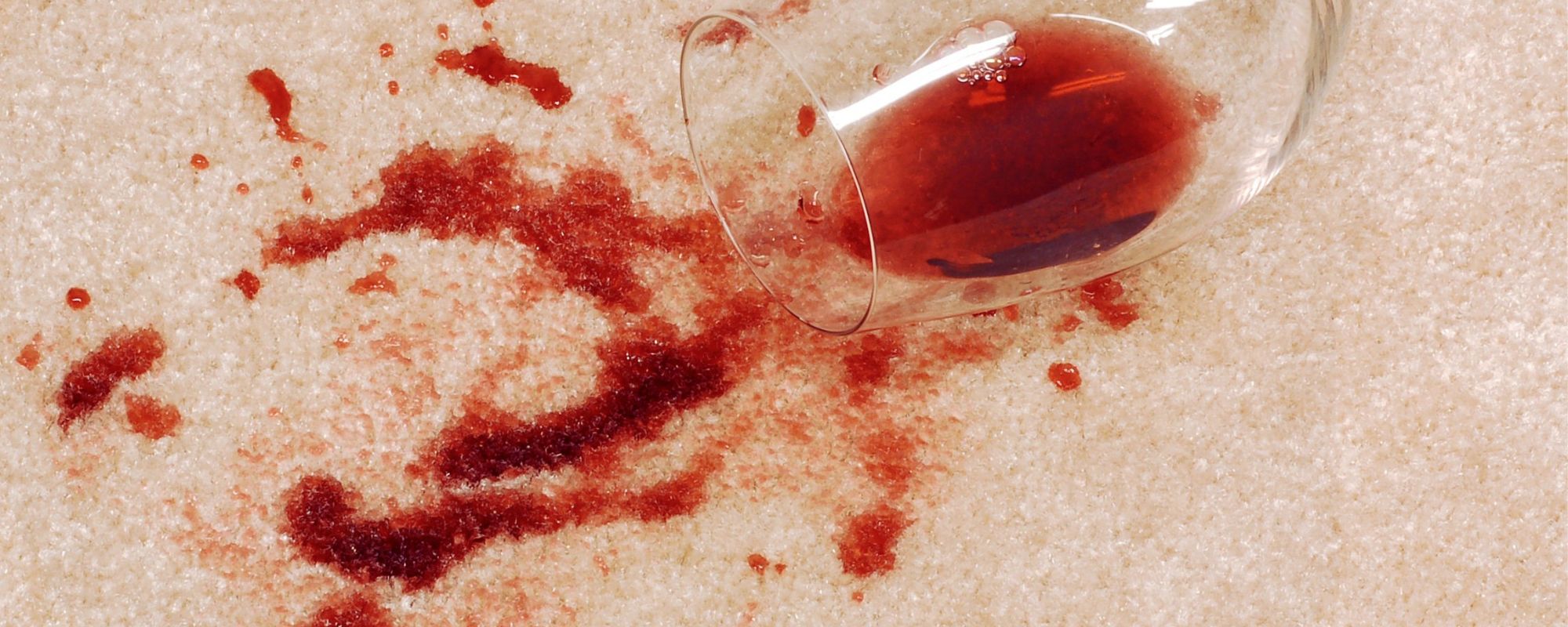 Red wine spilled on beige carpet.