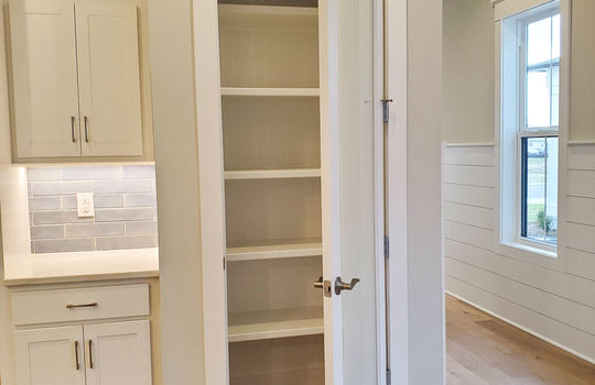 A reach-in pantry, door opened, inside a luxury home in Waterstone.