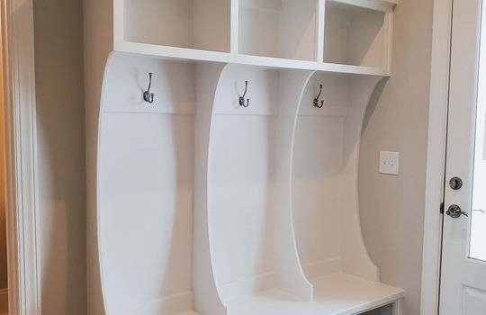 A drop zone with 3 hooks, 3 top cubbies, and 3 shoe cubbies.