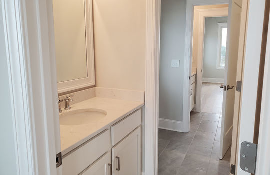 A dressing area with a vanity and mirror.