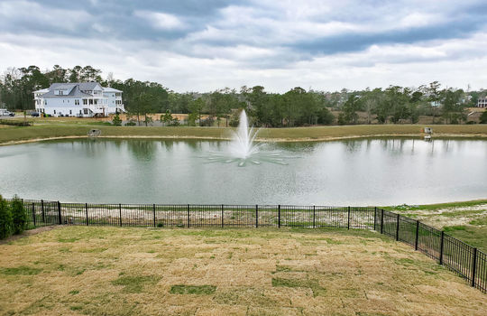 The fenced back yard and views of the pond in Waterstone.