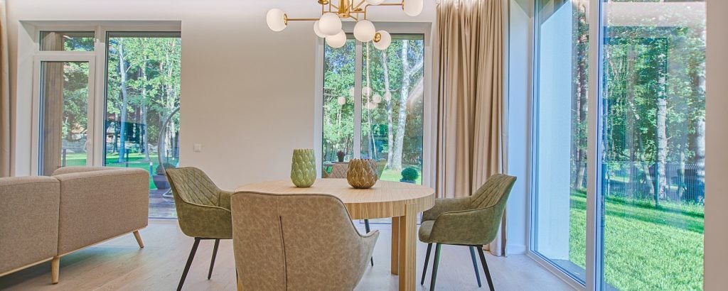 A dining room with a modern light fixture.