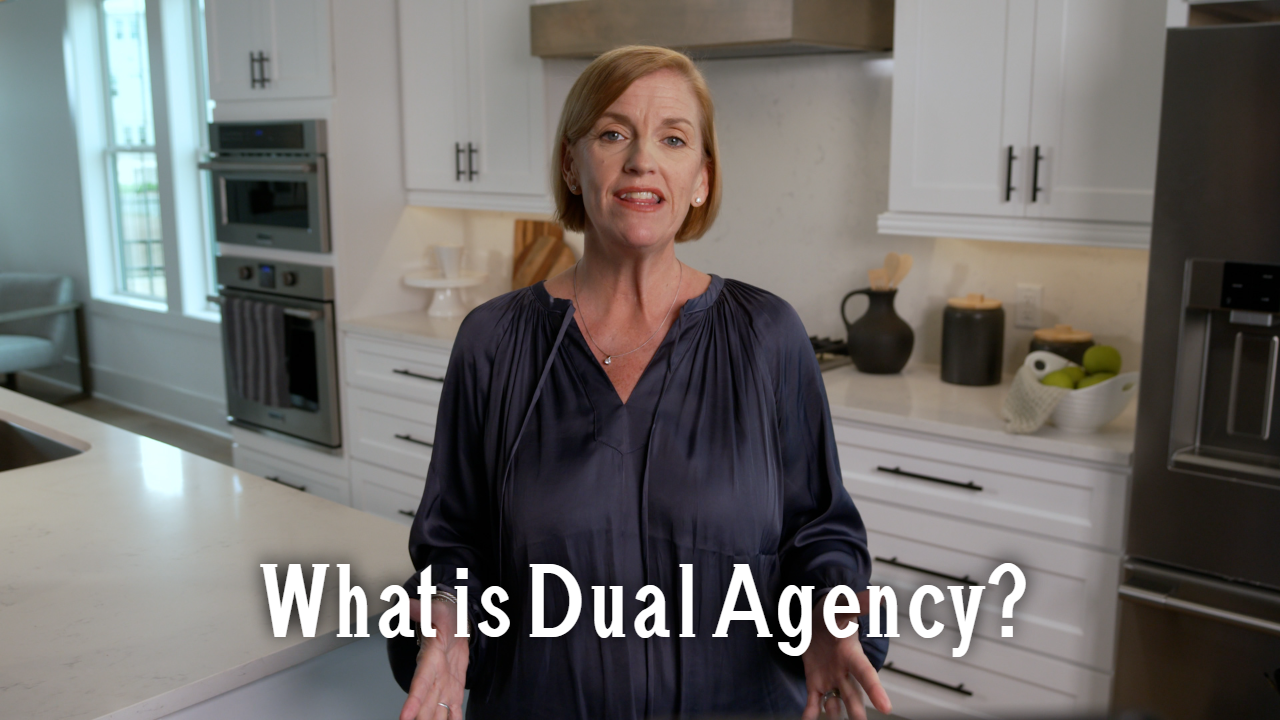 "What is Dual Agency" over Melanie Cameron standing in a kitchen.