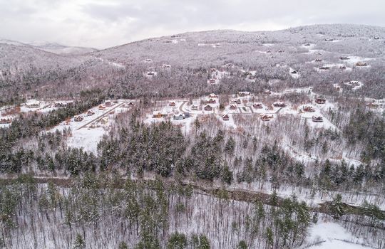 Aerial view of Peaks Village covered in snow