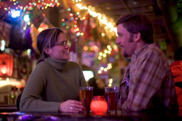 Couple discussing over drinks