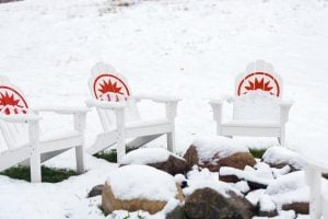 Adirondack chairs covered in snow