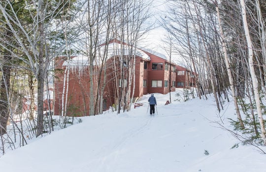 Skier returning to condo from slopes