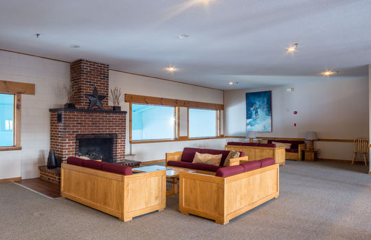 Common room with couches and fireplace at Sunrise Condo