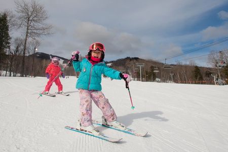 Smiling kids skiing on South Ridge