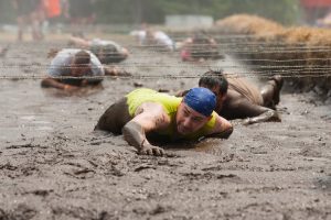 Competitor in mud during the Tough Mountain Challenge