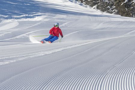 Skier carving on corduroy