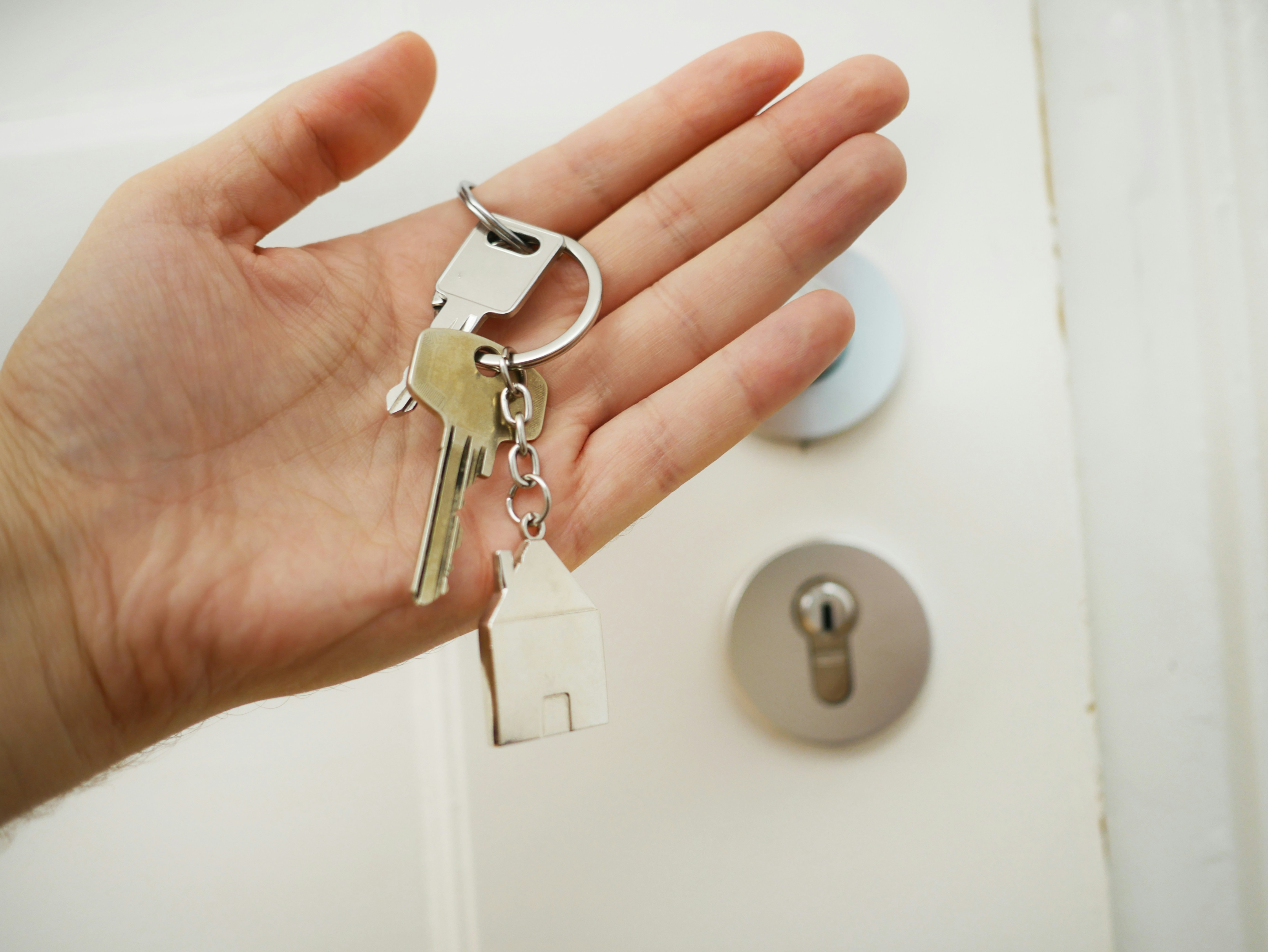 hands with keys to new home