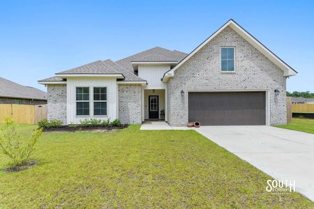 Front view of upgraded energy-efficient home for sale in Gulfport MS with landscaped yard.