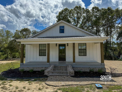 Front view of 2025 white board-and-batten home with covered porch at 14 Mixon Road, New Augusta