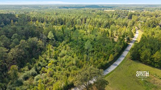 Aerial view along N. Mill Creek Road with wooded acreage and the surrounding landscape.